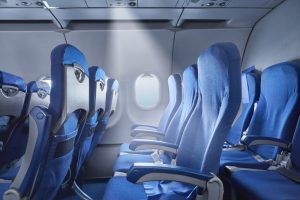 SelectFocusOnModernCommercialAirplaneSeatRowInBright - Mann Travel Canada